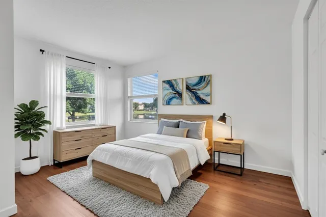 a bedroom with a bed and a potted plant