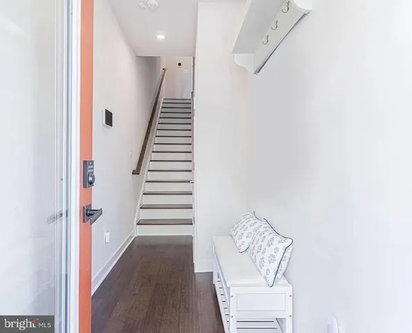 a view of entryway and hall with wooden floor