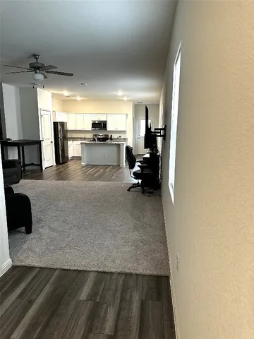 a kitchen with a sink a microwave a refrigerator and cabinets