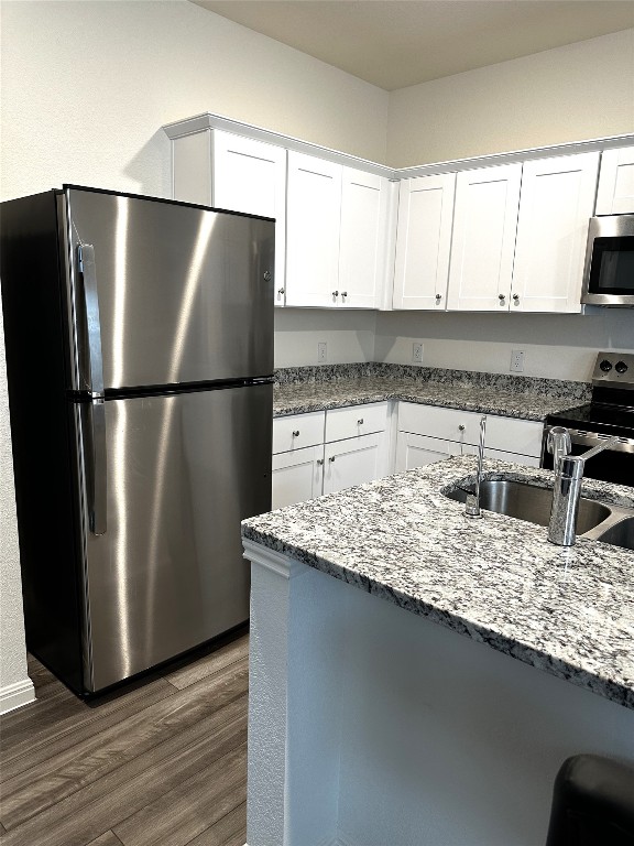 207 Enforcer Loop Jarrell, TX 76537 - Photo 5 of 15 a kitchen with a refrigerator and a sink