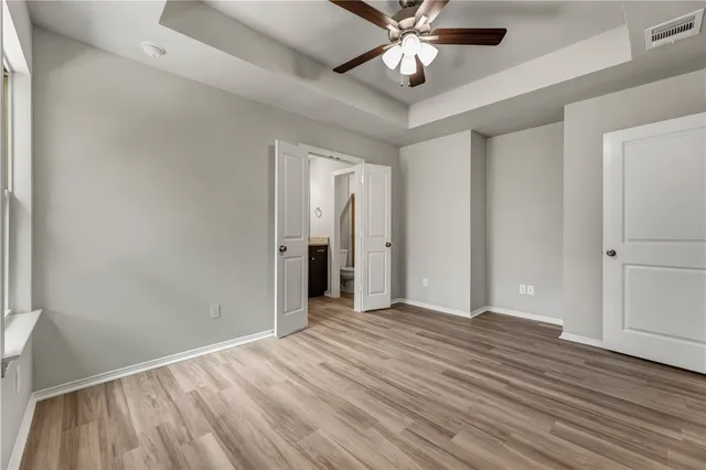 a view of an empty room and wooden floor