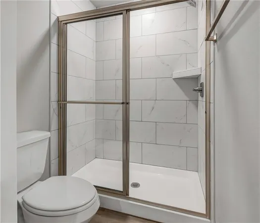 a white toilet sitting next to a bathtub
