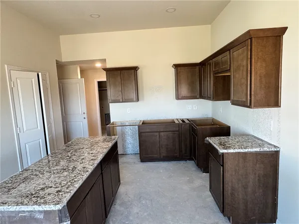 a kitchen with a sink stove and refrigerator