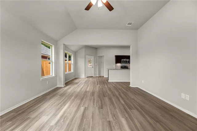 wooden floor in an empty room with a window