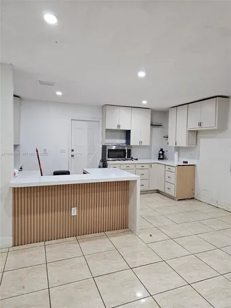 a open kitchen with cabinets and stainless steel appliances