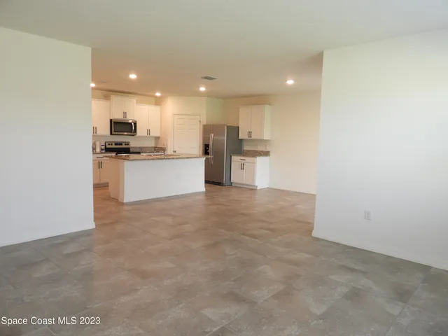 a open kitchen with a sink and white cabinets