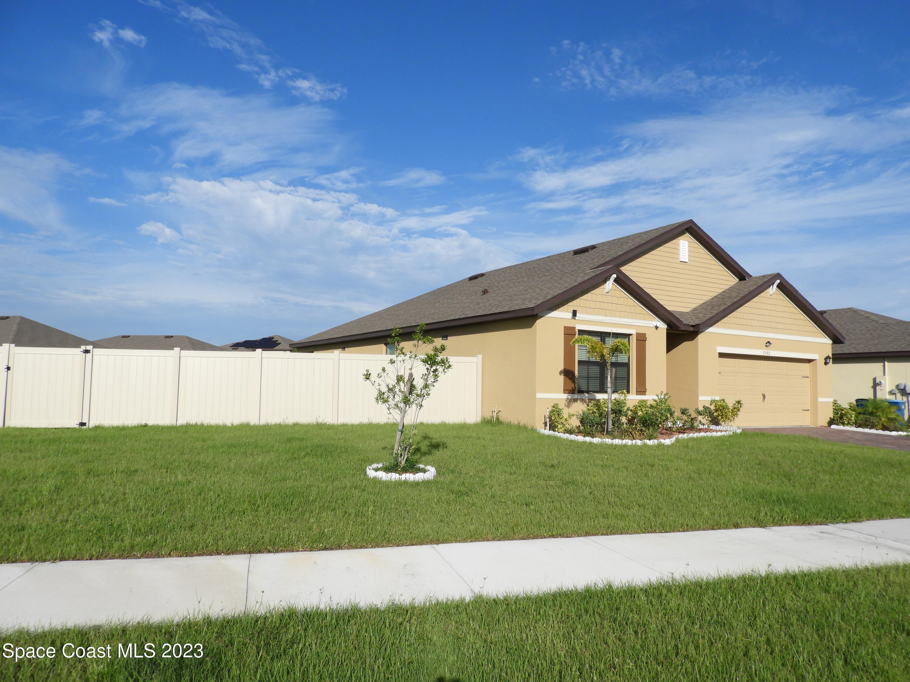 3782 Coachman Lane Southeast Palm Bay, FL 32909 - Photo 2 of 31 a front view of a house with a yard