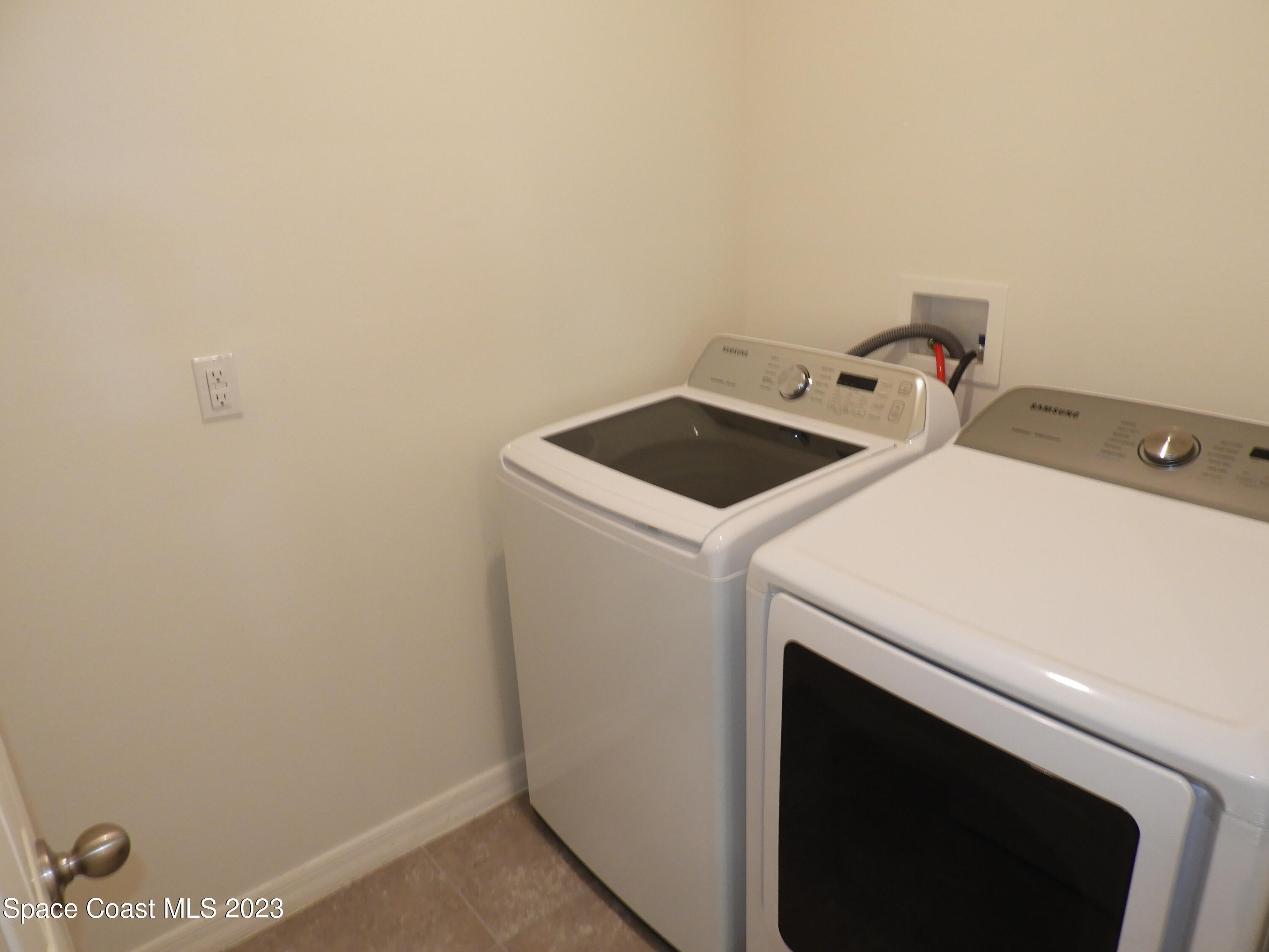 3782 Coachman Lane Southeast Palm Bay, FL 32909 - Photo 27 of 31 a utility room with dryer and washer