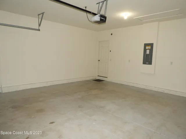 a view of a house with a yard and a large tree