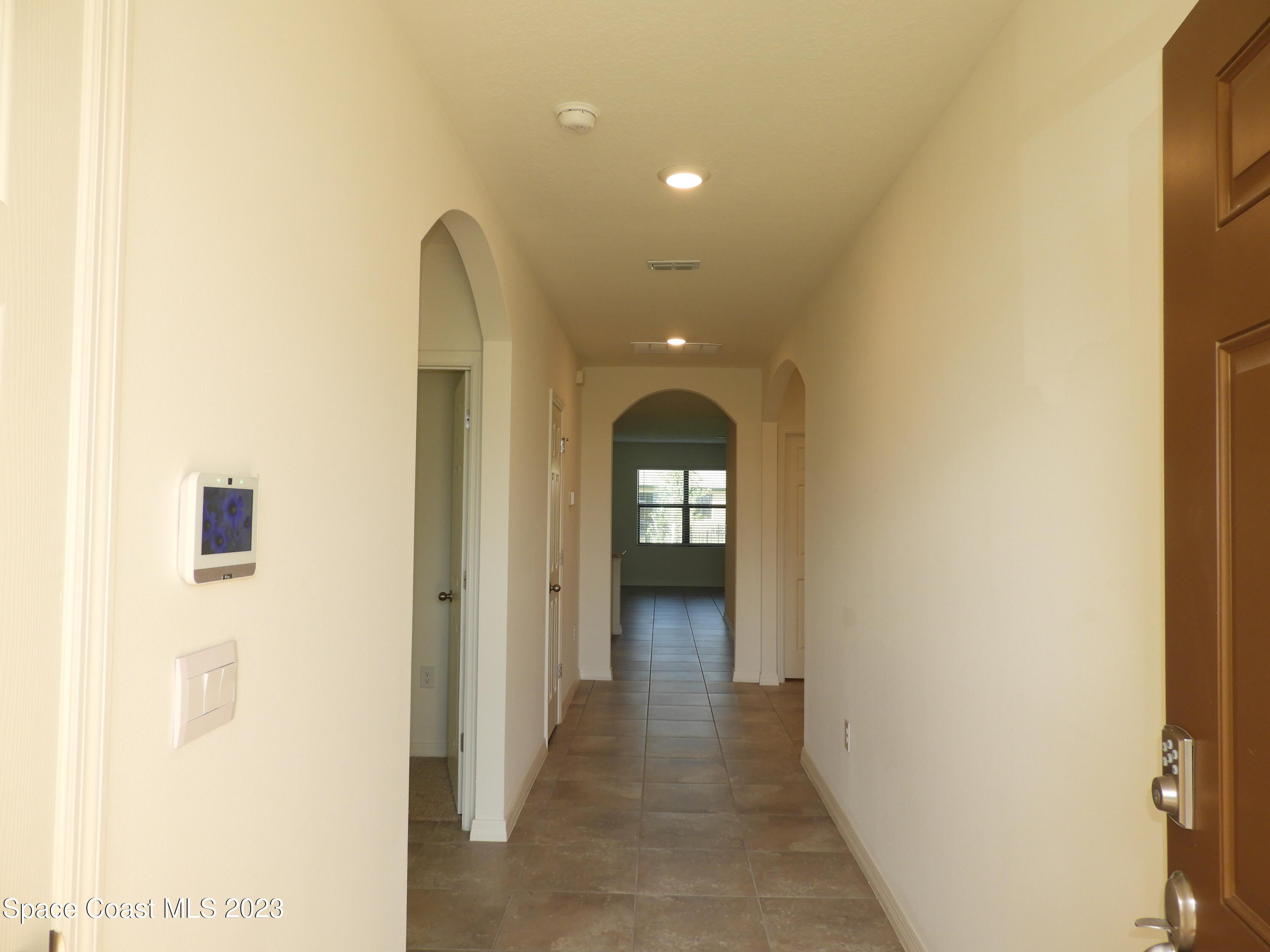 3782 Coachman Lane Southeast Palm Bay, FL 32909 - Photo 5 of 31 a view of a hallway with wooden floor