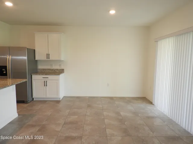 a view of a kitchen with refrigerator