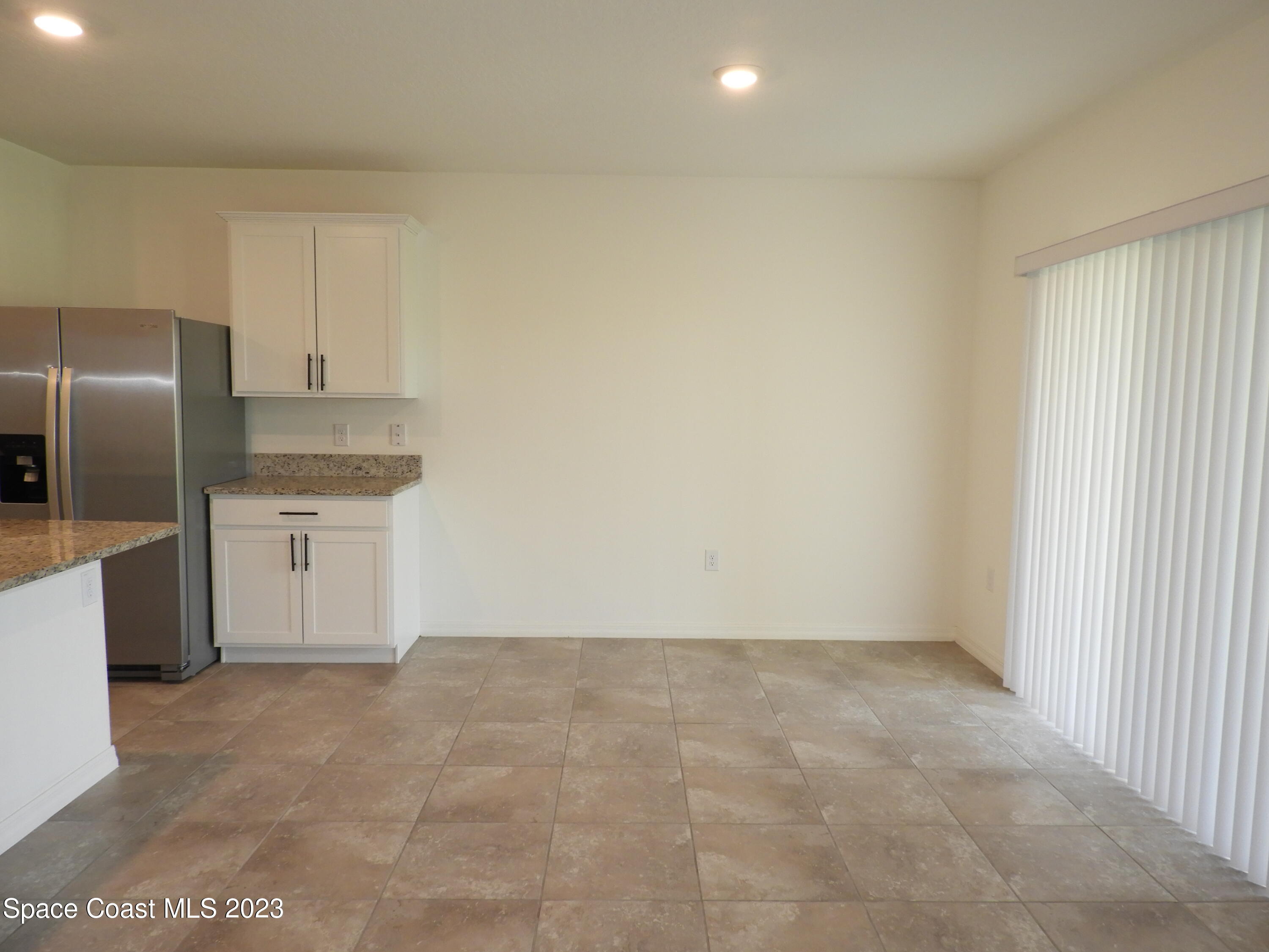 3782 Coachman Lane Southeast Palm Bay, FL 32909 - Photo 8 of 31 a view of a kitchen with refrigerator