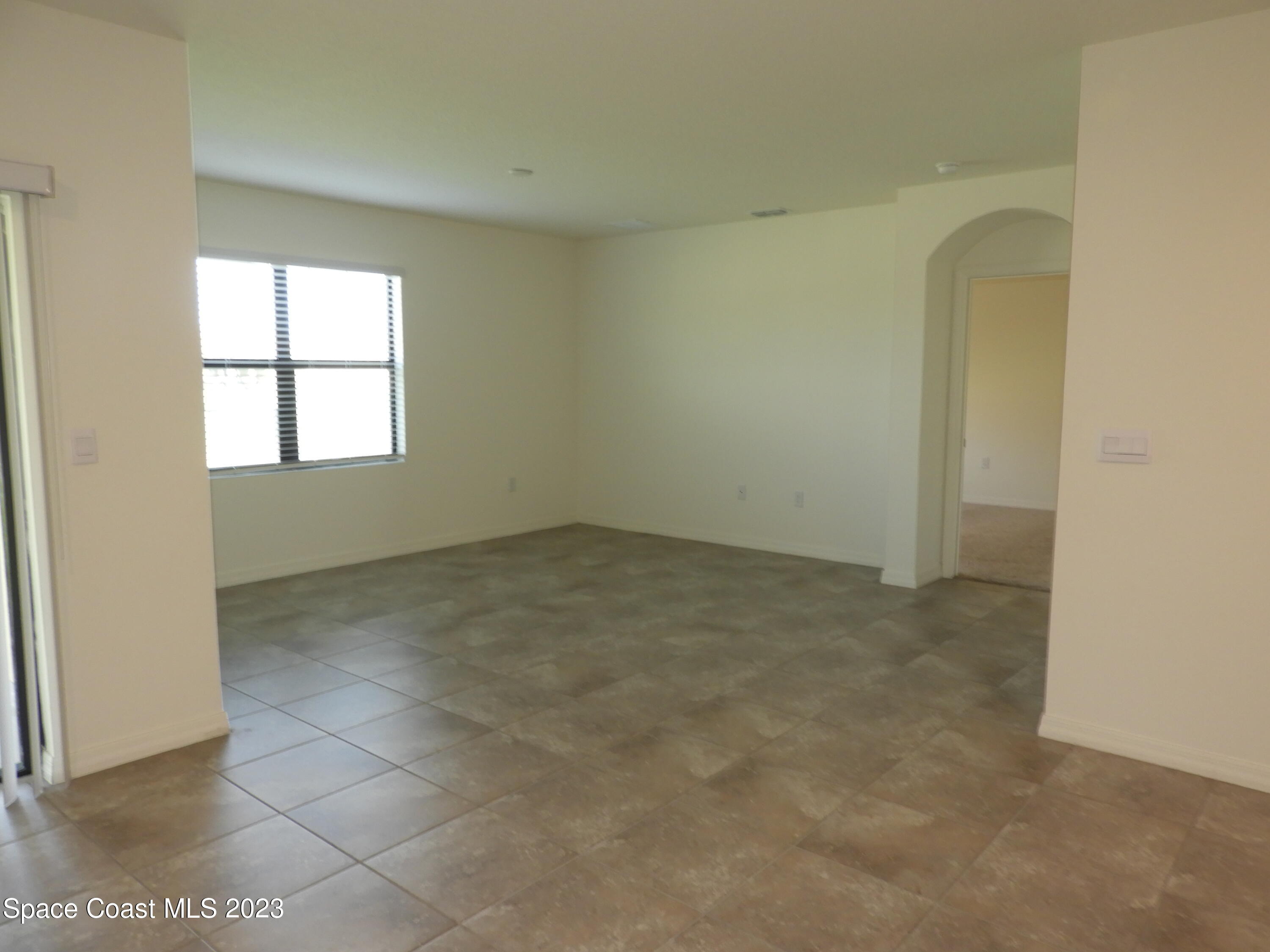 3782 Coachman Lane Southeast Palm Bay, FL 32909 - Photo 9 of 31 an empty room with windows