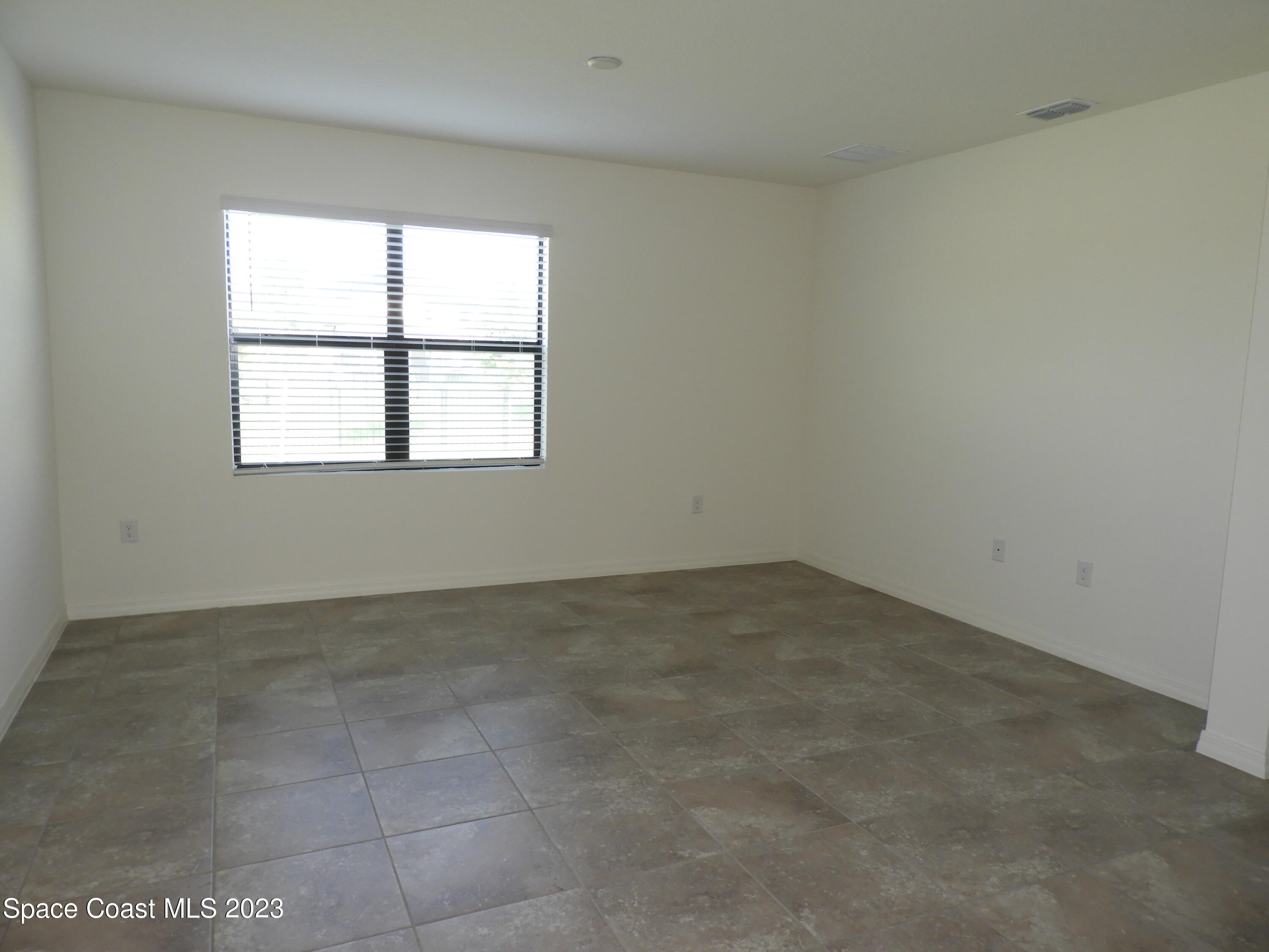 3782 Coachman Lane Southeast Palm Bay, FL 32909 - Photo 10 of 31 an empty room with a window