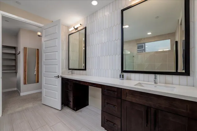 a bathroom with a sink a toilet and mirror