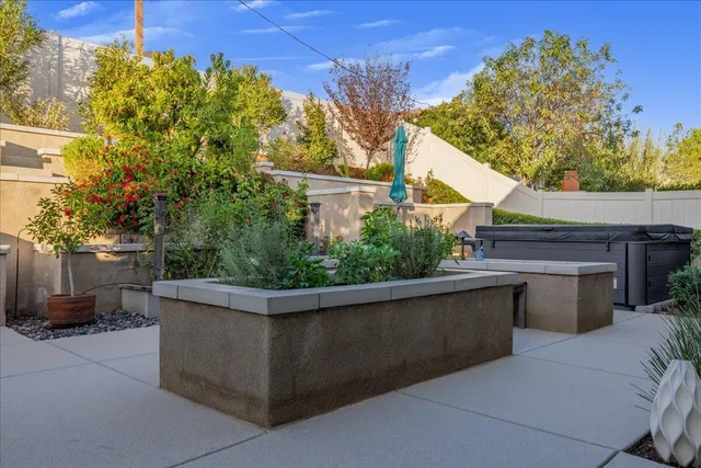 an aerial view of a house with garden space and sitting area