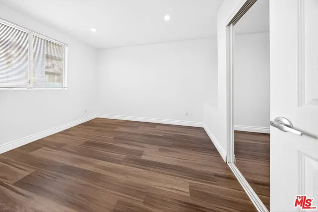 a view of a room with wooden floor and staircase