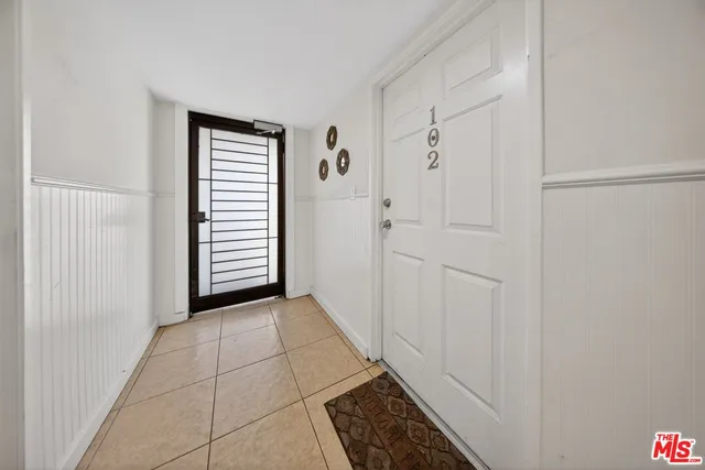 a view of a hallway with closet and bathroom