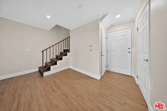 a view of an entryway with wooden floor