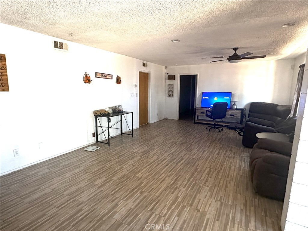 14822 Rodeo Drive Victorville, CA 92395 - Photo 3 of 8 a living room with furniture and a fireplace