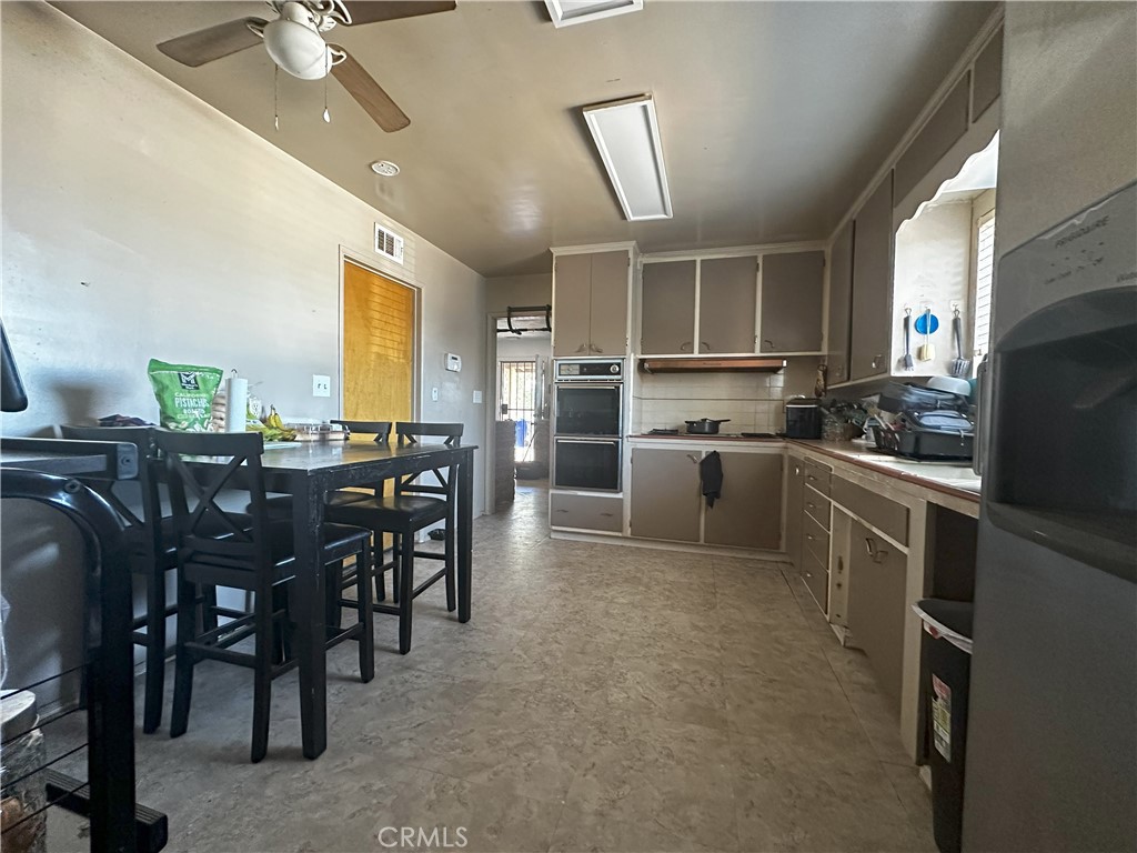 14822 Rodeo Drive Victorville, CA 92395 - Photo 5 of 8 a kitchen with cabinets a sink and appliances
