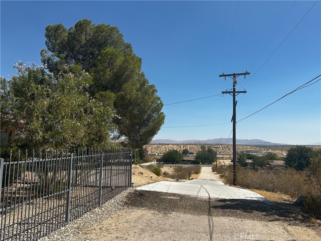 14822 Rodeo Drive Victorville, CA 92395 - Photo 6 of 8 a outdoor view of a house with a cars park