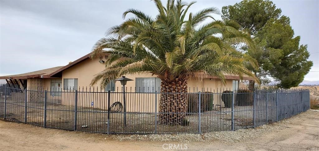 14822 Rodeo Drive Victorville, CA 92395 - Photo 8 of 8 a white house that has a tree in front of it