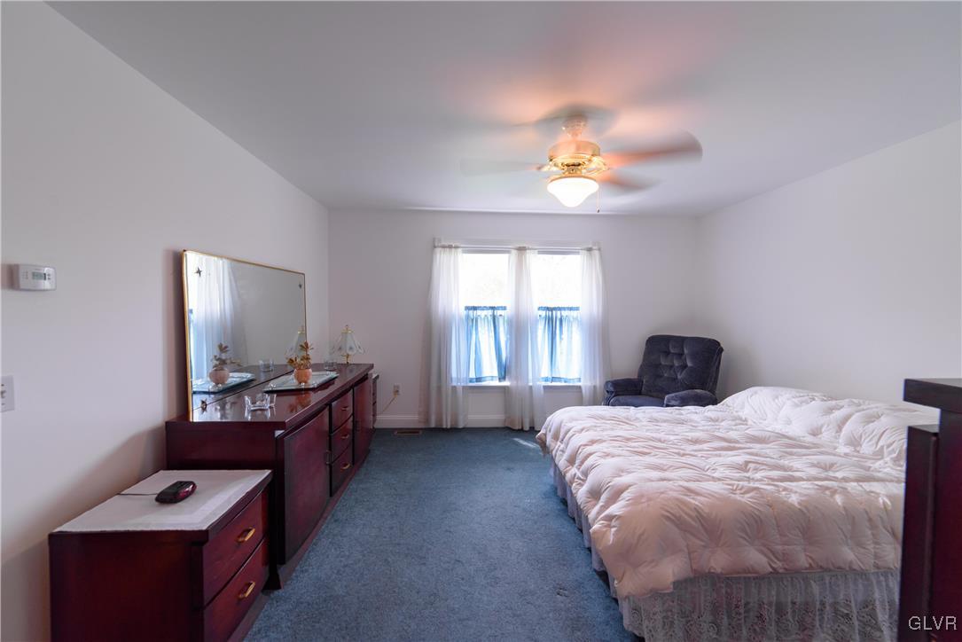 1213 Seifert Road Nazareth, PA 18064 - Photo 12 of 25 a bedroom with a bed and a flat tv screen on a dresser