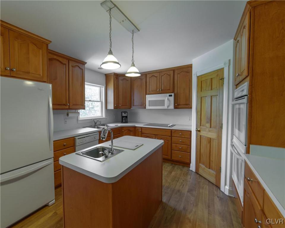 1213 Seifert Road Nazareth, PA 18064 - Photo 7 of 25 a kitchen with a sink a stove a refrigerator and cabinets