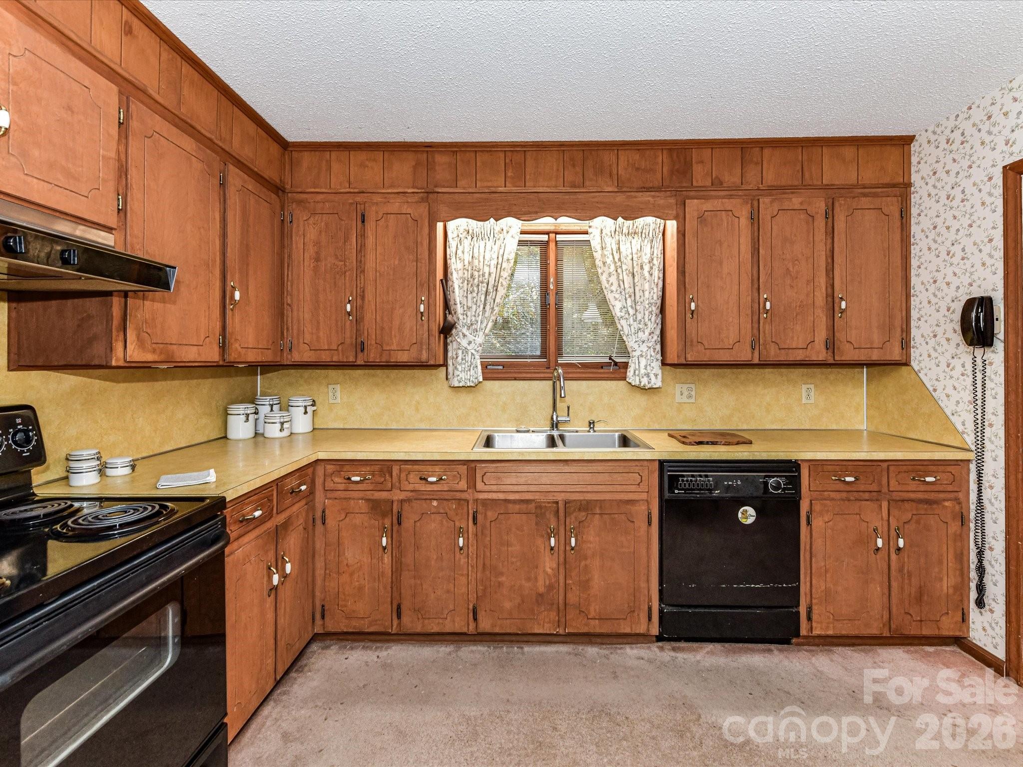 127 Todd Circle Wingate, NC 28174 - Photo 11 of 36 a kitchen with stainless steel appliances granite countertop a sink a stove and a refrigerator