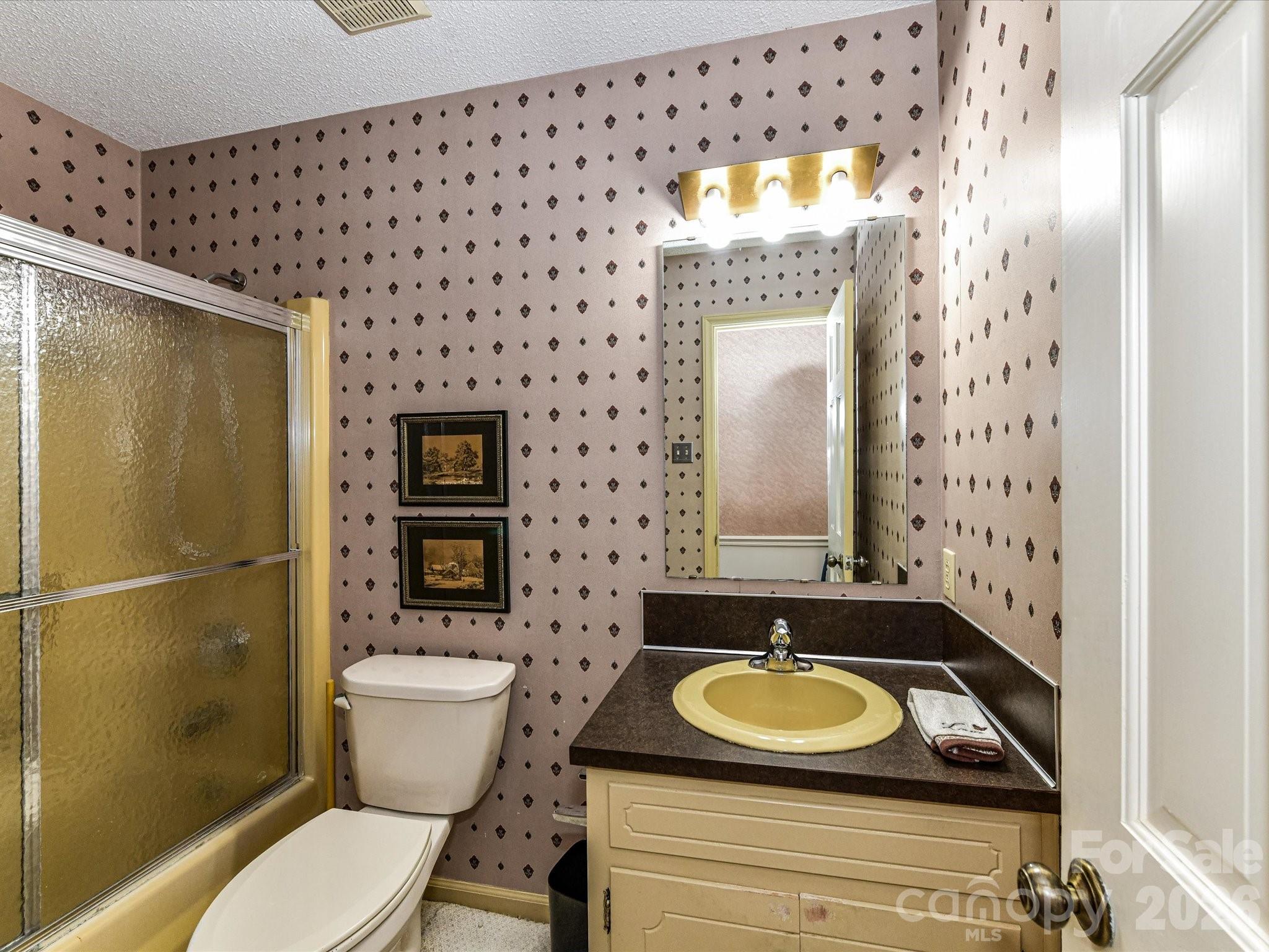 127 Todd Circle Wingate, NC 28174 - Photo 27 of 36 a bathroom with a sink a toilet and shower