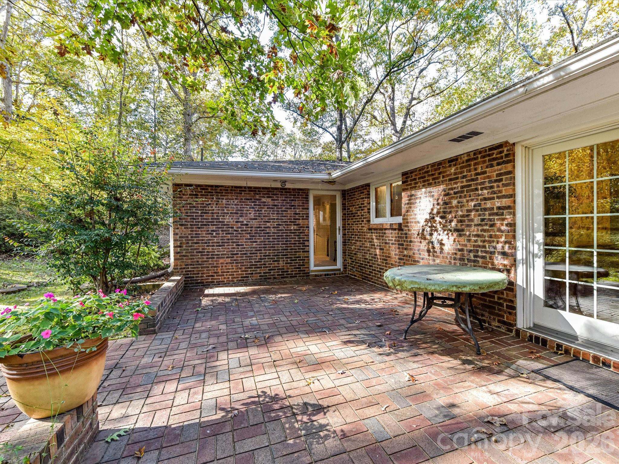 127 Todd Circle Wingate, NC 28174 - Photo 31 of 36 a view of a backyard with table and chairs and potted plants
