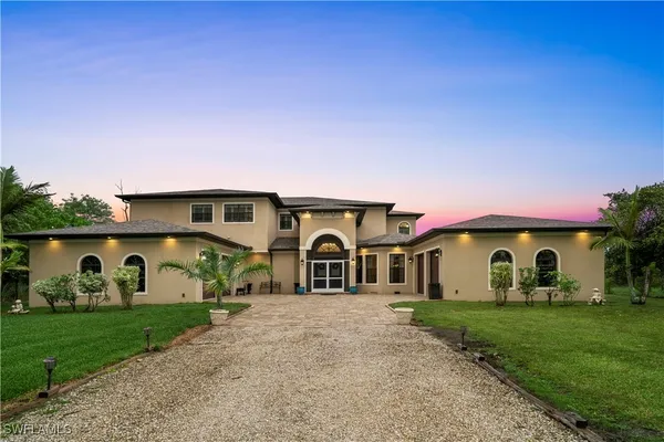 a front view of a house with garden