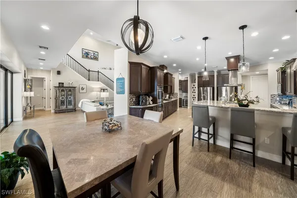 a dining room with furniture and wooden floor