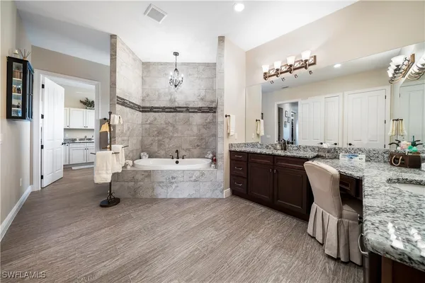 a kitchen with kitchen island a sink and a refrigerator