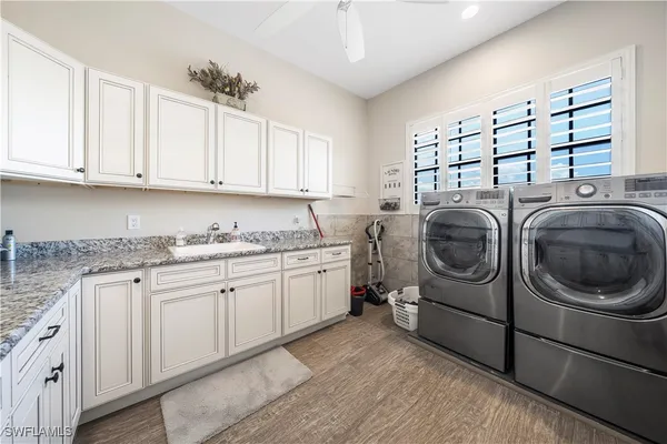 a utility room with sink dryer and washer