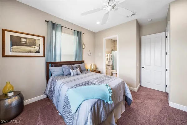 a spacious bedroom with a bed and a chandelier