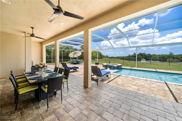 a view of a patio with a table chairs and a backyard