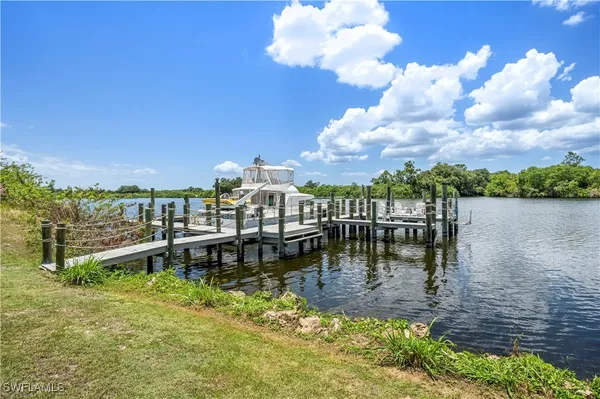 a view of a lake with houses in back