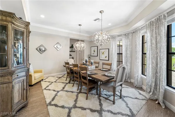 a view of a dining room with furniture and chandelier