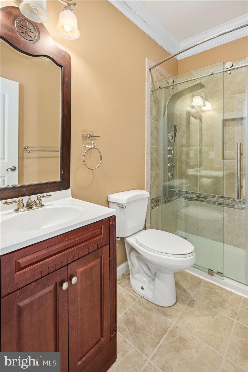 11846 Chapel Road Clifton, VA 20124 - Photo 88 of 143 a bathroom with a granite countertop toilet sink and a mirror