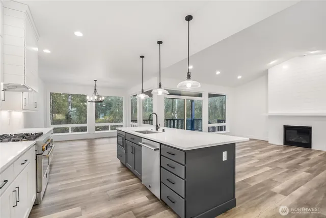a view of a kitchen with a sink and a fireplace