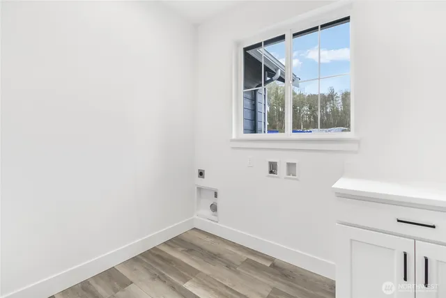 a view of empty room with window and chandelier