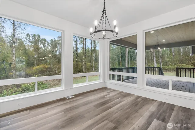 a large kitchen with kitchen island a sink a counter and a view of living room