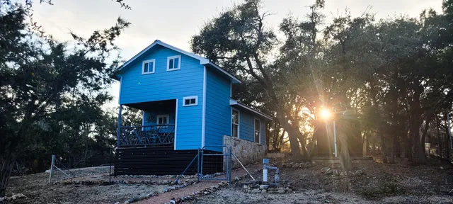 a view of a house with large trees
