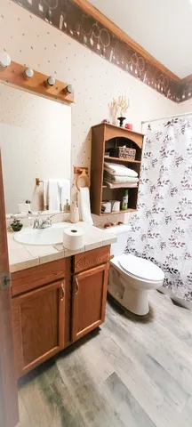 a bedroom with double bed and a night stand