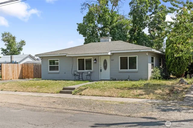 a house that has a tree in front of it