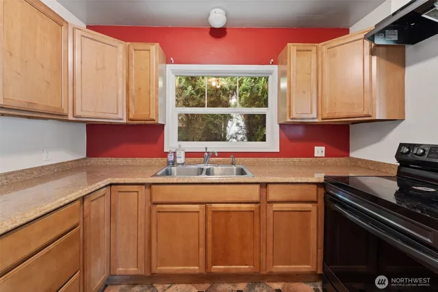 a kitchen with stainless steel appliances granite countertop a sink and a cabinets