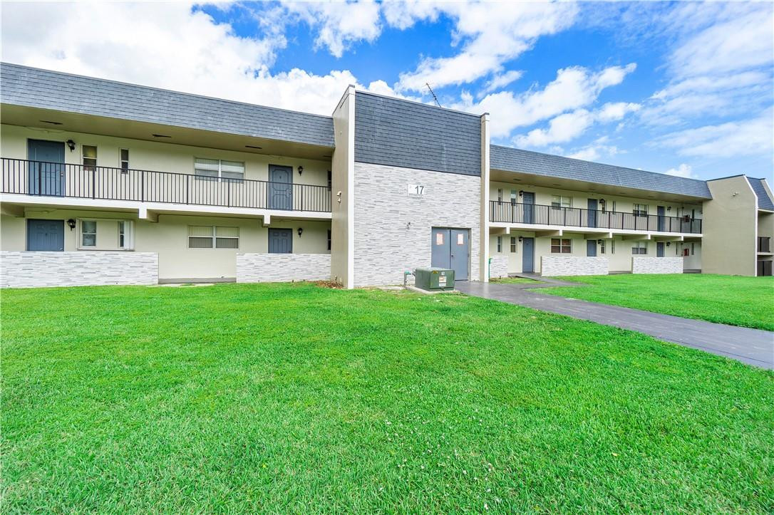 8025 South Colony Circle, Unit 106 Tamarac, FL 33321 - Photo 13 of 14 a house with garden in front of it