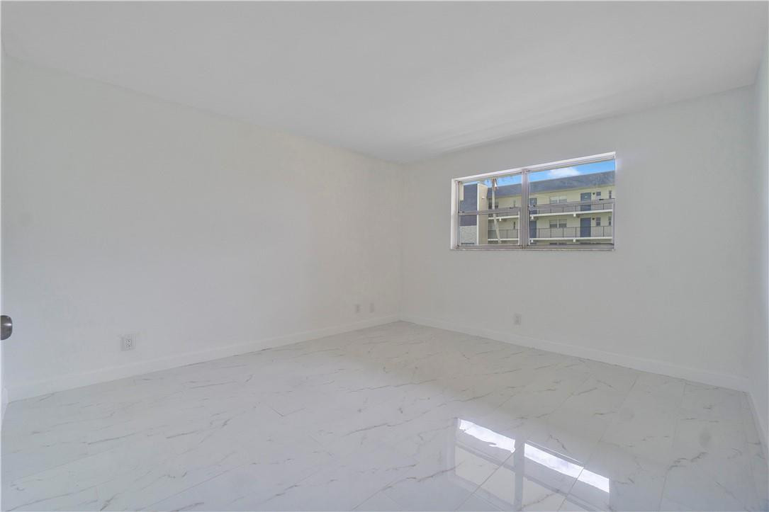 8025 South Colony Circle, Unit 106 Tamarac, FL 33321 - Photo 6 of 14 an empty room with a empty space and windows